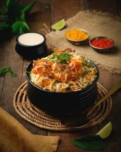 Chicken biryani in a black bowl with raita and condiments – Indian restaurant menu photography, Dubai
