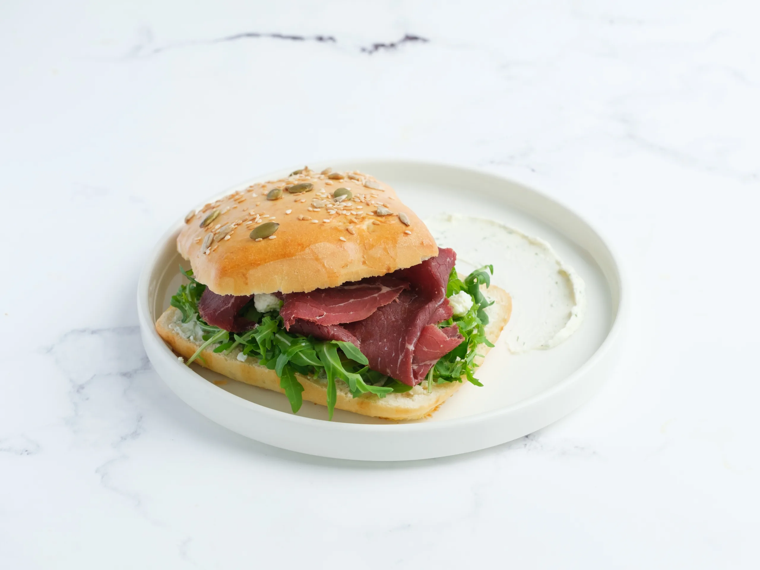 Roast beef sandwich on a white plate – café menu photography, Dubai