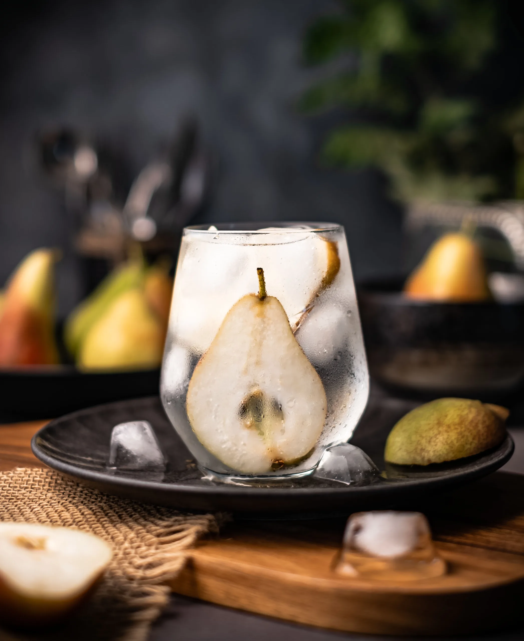 Poached pear in a glass with fresh pears – dark and moody dessert photography, Dubai
