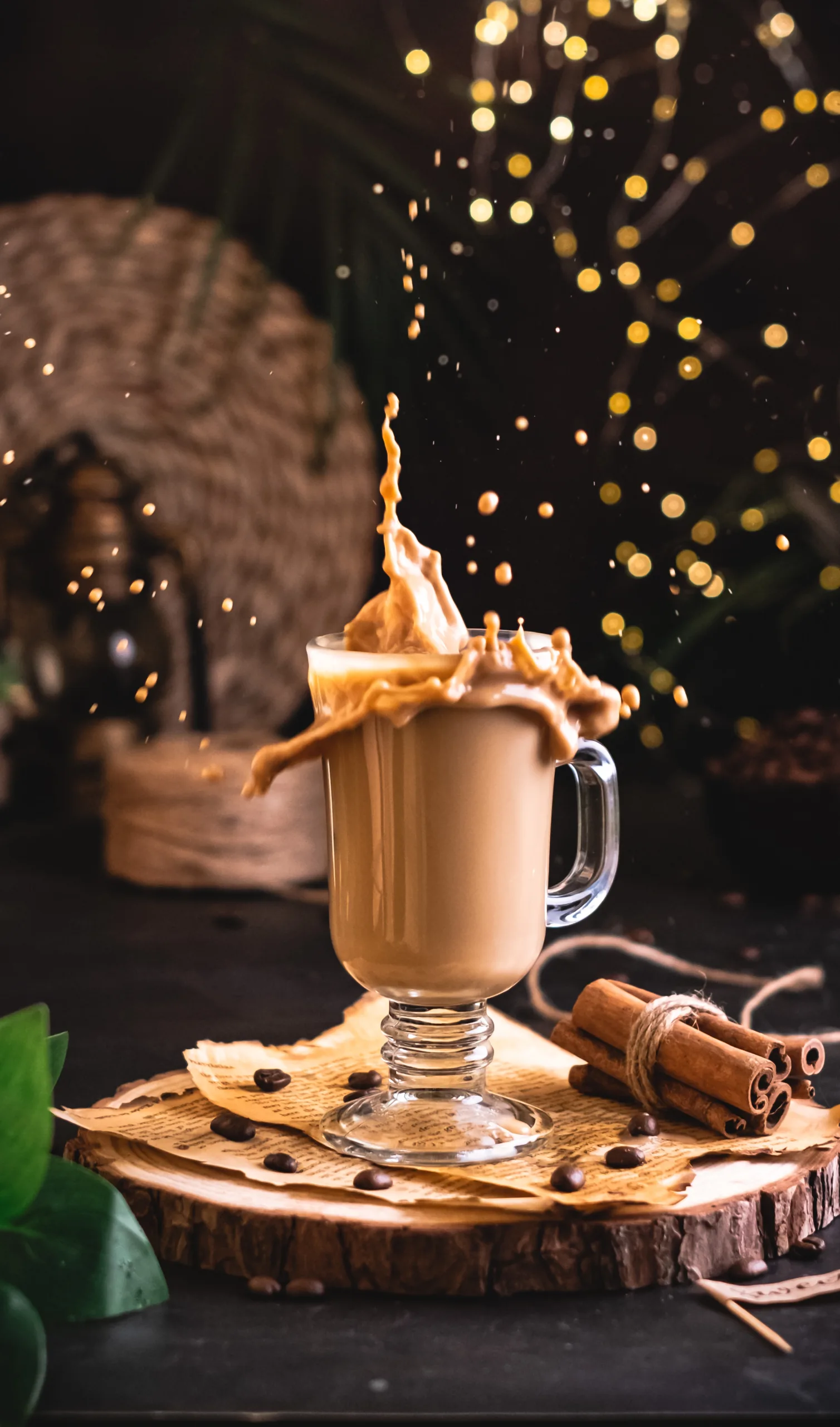 Coffee splashing out of a glass mug with cinnamon sticks – action beverage photography, Dubai