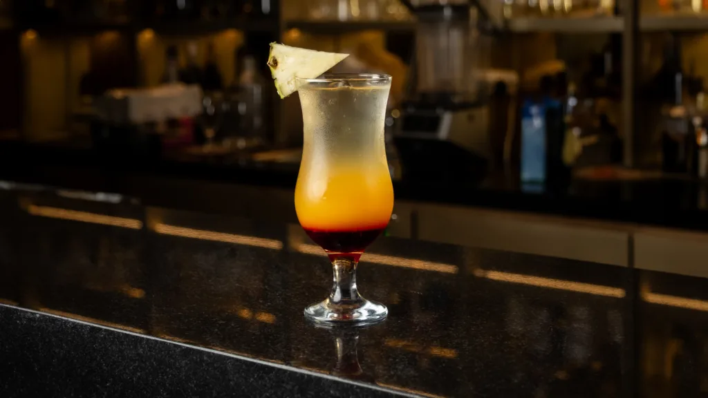 Layered tropical cocktail on a bar counter – social media drink photography, Dubai