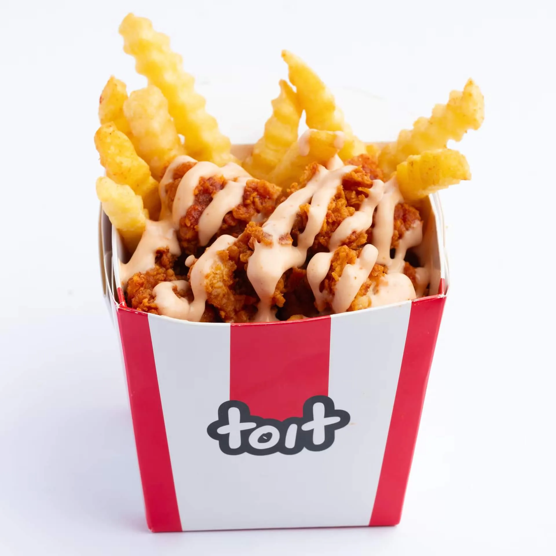 Loaded fries with crispy chicken and sauce in a Toit branded box – delivery-app food photography, Dubai