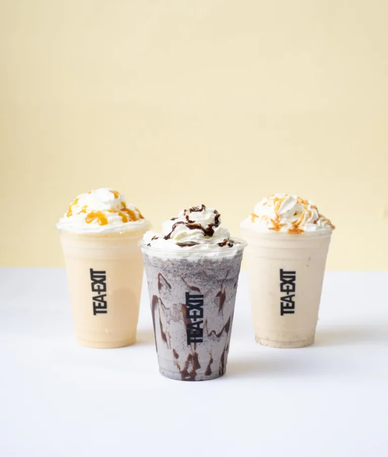 Two whipped-cream frappés in branded takeaway cups – café beverage photography, Dubai