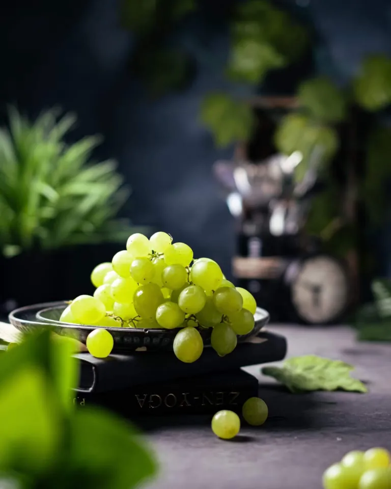 Fresh green grapes on a dark surface in soft light – fruit and produce photography, Dubai
