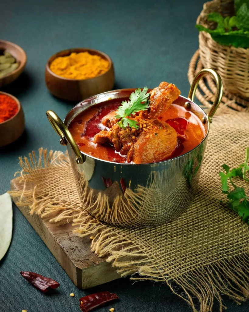 Chicken masala curry in a copper kadai with fresh coriander – Indian restaurant food photography, Dubai