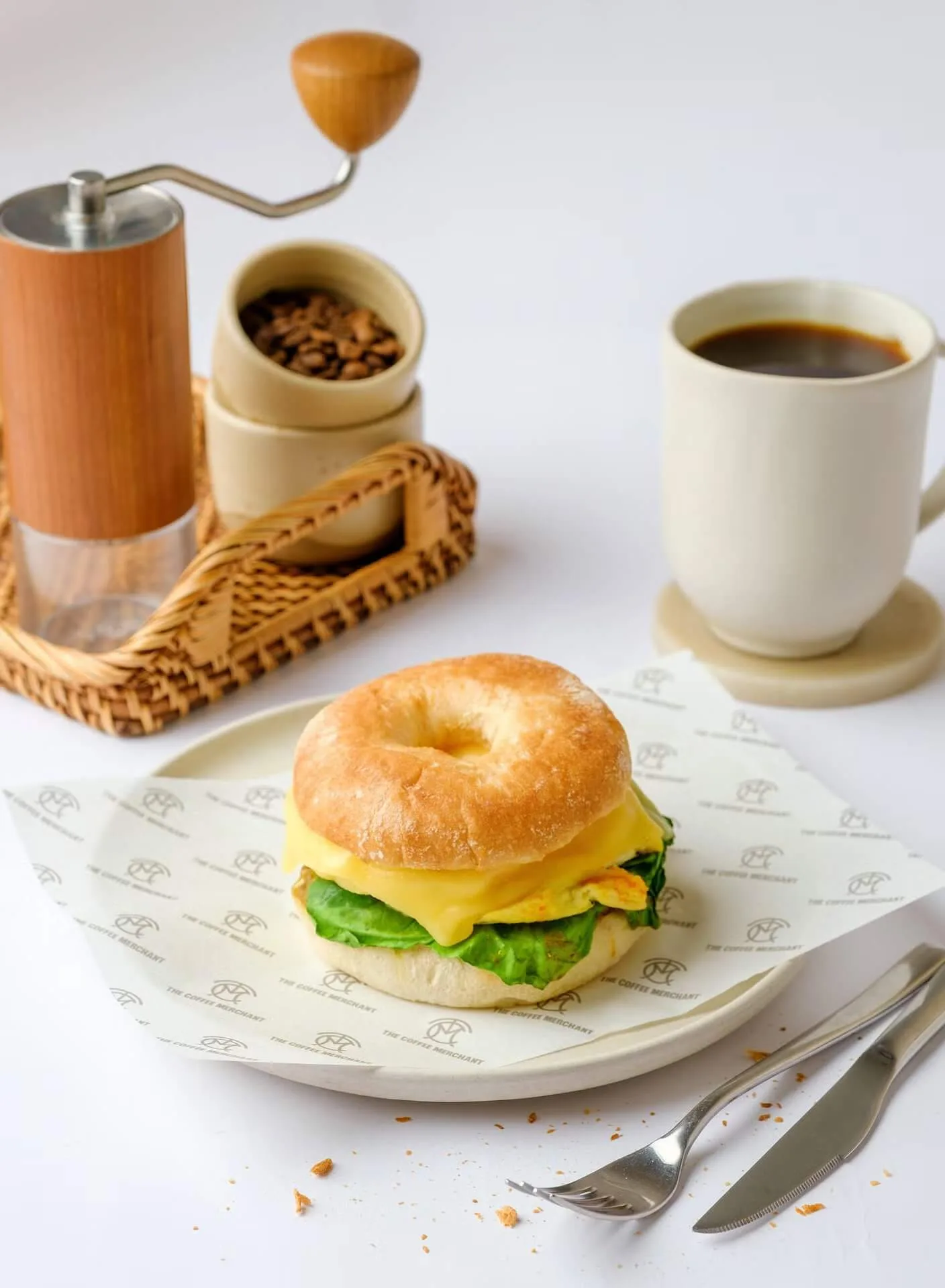 Breakfast bagel sandwich with egg and a cup of coffee – café menu photography, Dubai