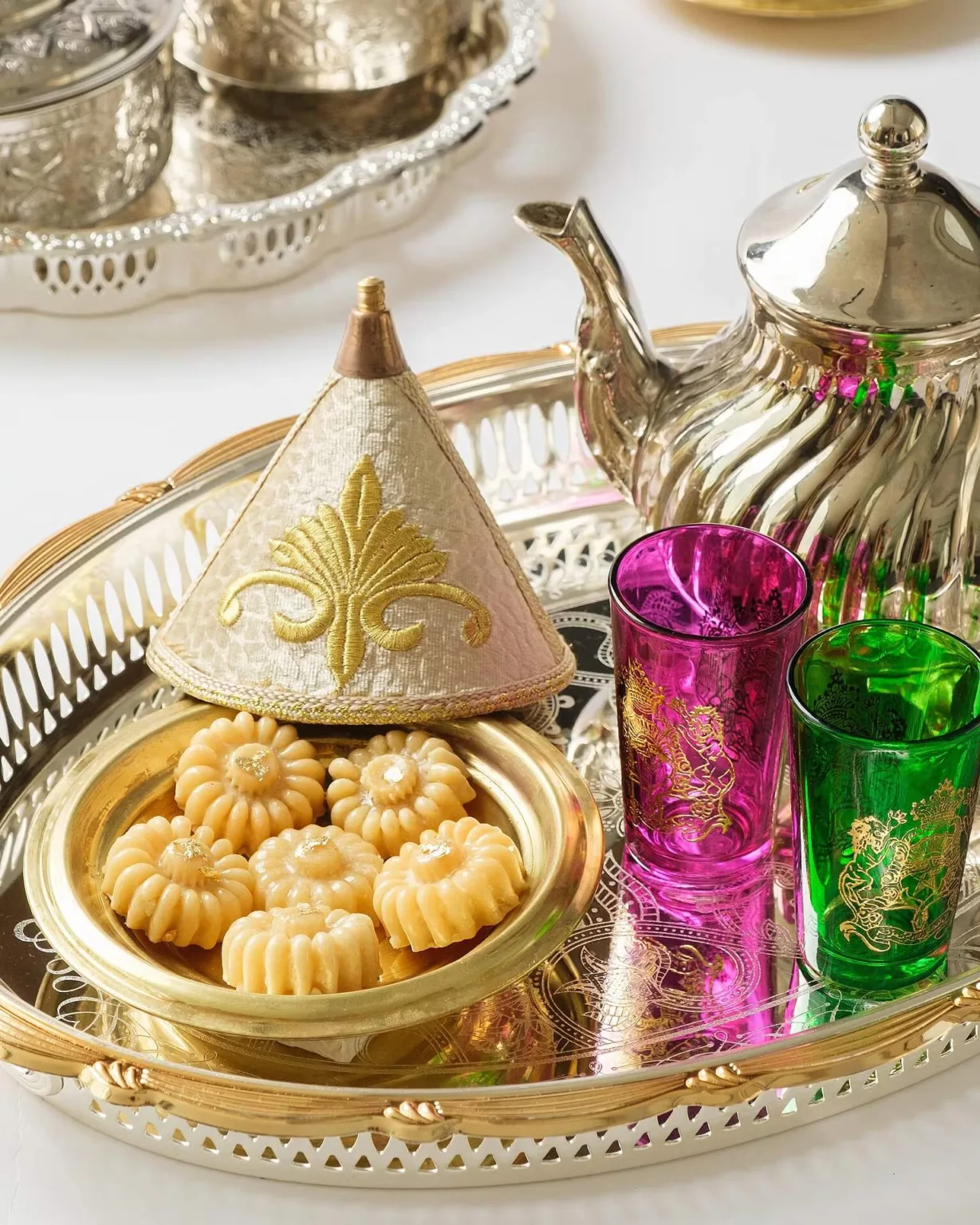 Arabic tea set with ma’amoul cookies, ornate teapot and coloured glasses – Middle Eastern food photography, Dubai