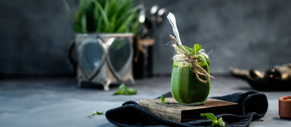 Green smoothie in a glass with a straw – beverage photography by My Pinch of Wow, Dubai